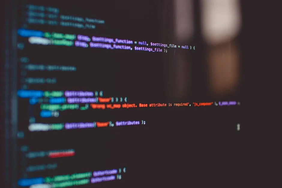 Dual monitors on a desk, showcasing web design in a modern office setting.